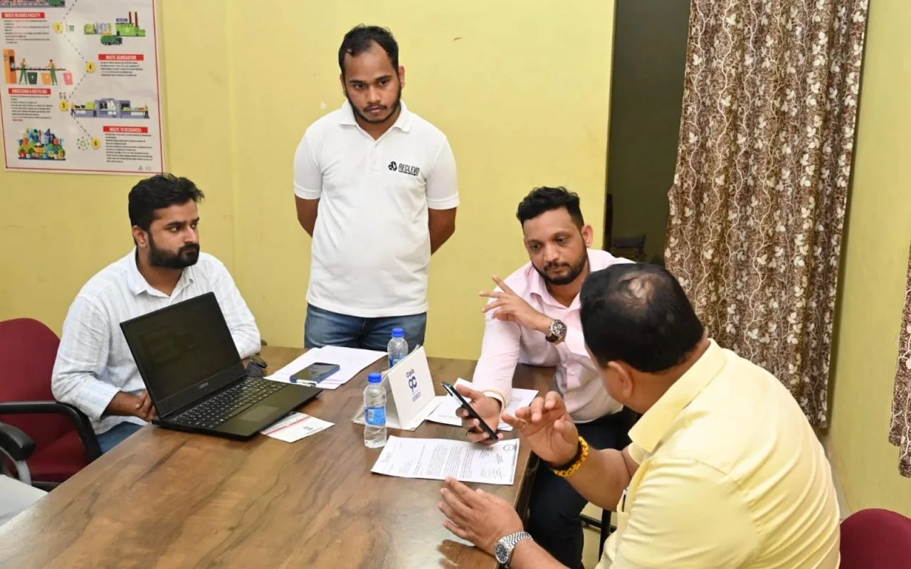 Minister Mauvin Godinho reviewing Reclevo's live waste-monitoring dashboard with the team